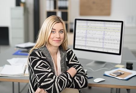 Woman working at a desktop computer.